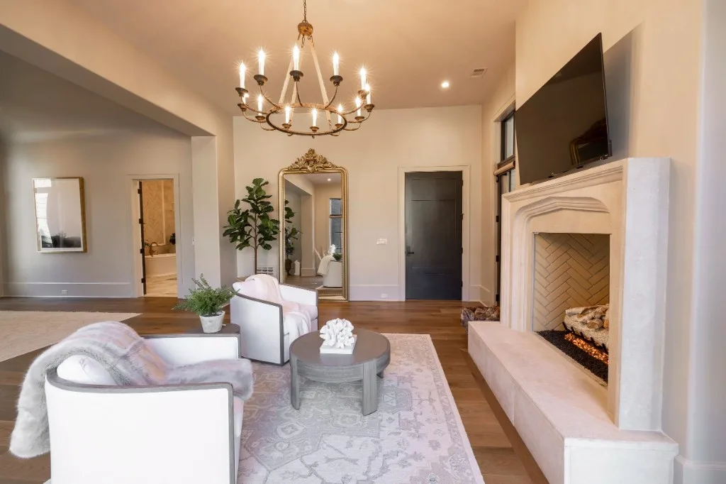 Berkeley Lake — sitting room with cast-stone fireplace and gilt mirror