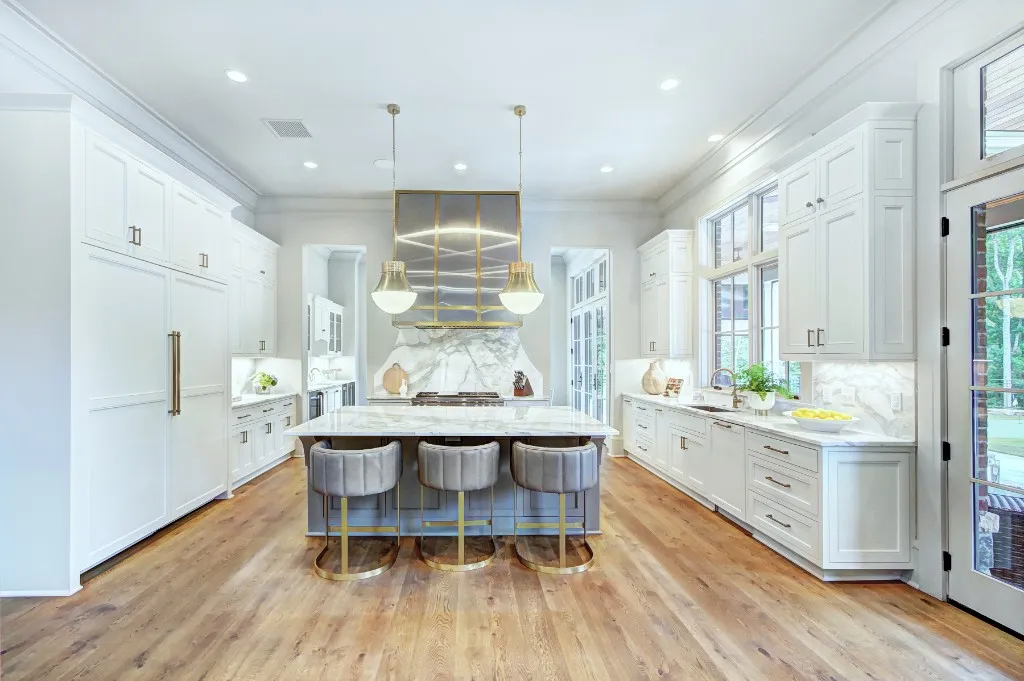 Mtn Lake — white kitchen with marble island and brass fixtures