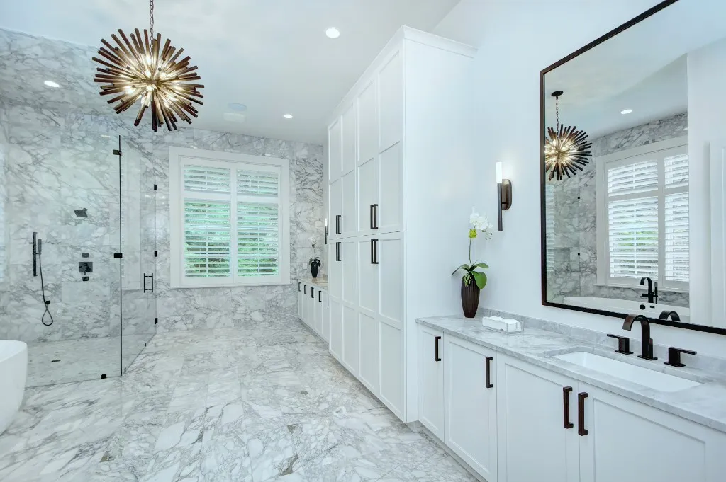Mtn Lake — primary bath in marble with starburst chandelier